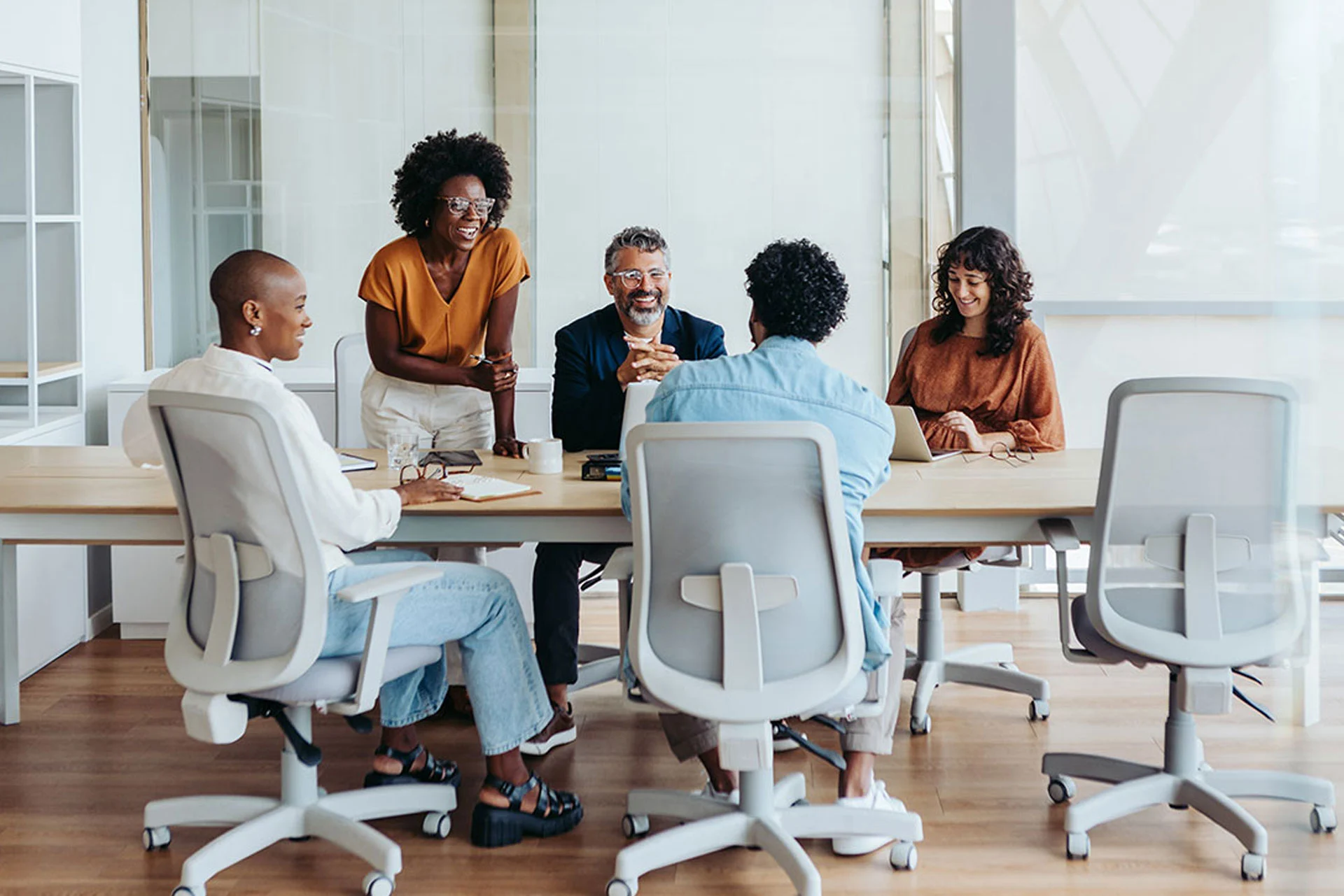 A collaborative meeting at a conference table with individuals sharing ideas to inspire limitless success