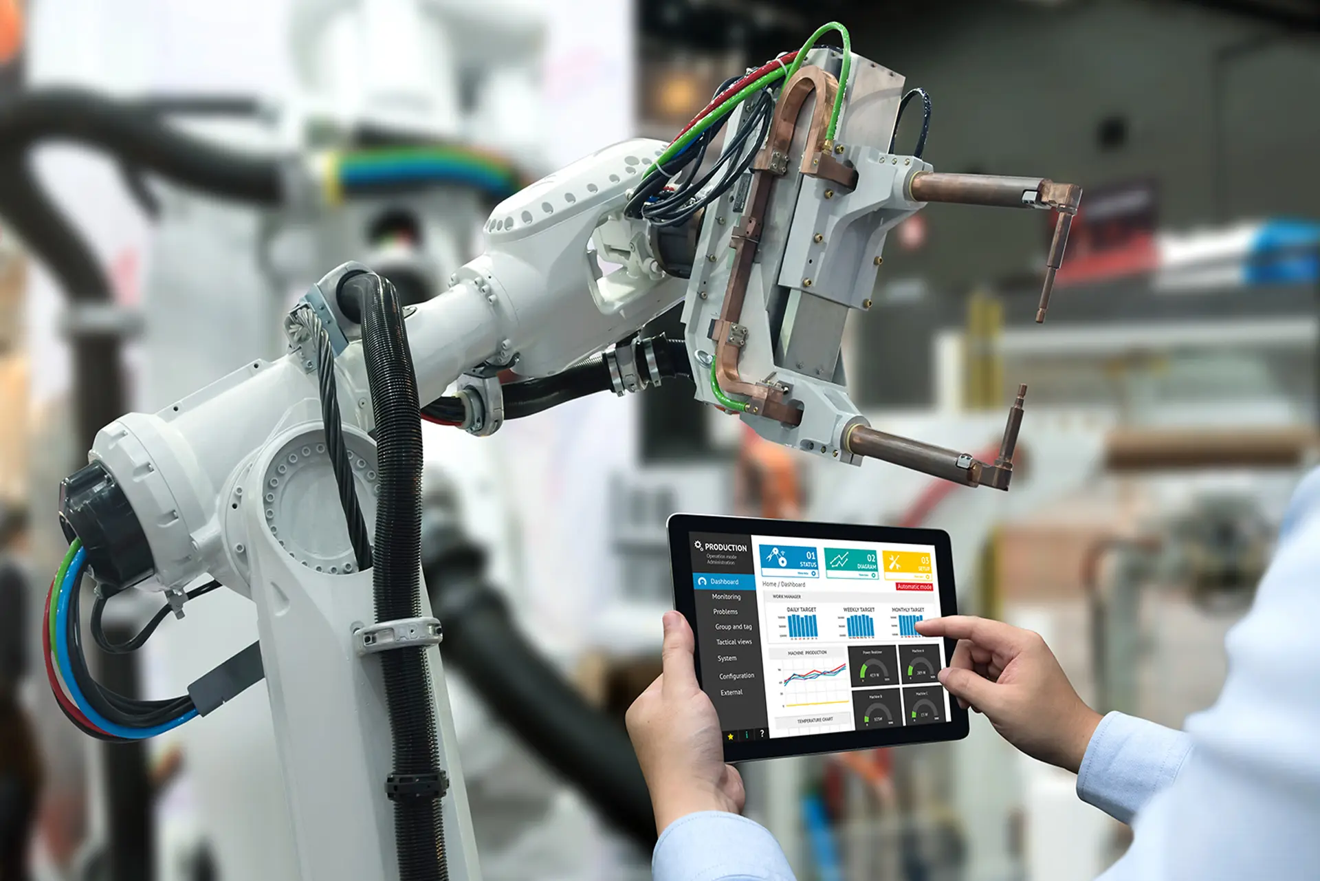 Individual with a tablet facing a robot, representing advancements in artificial intelligence and machine learning technology
