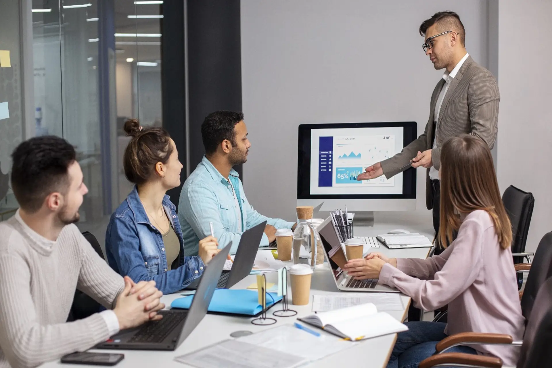 Man presents to a group of people about Enterprise IT Consulting, engaging the audience with his insights