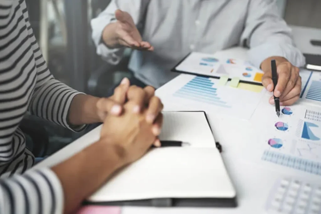 Business professionals reviewing financial reports and discussing strategies for capital investments in retirement planning