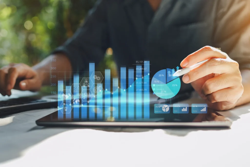 Businessman analyzing a tablet displaying a graph comparing passive income and capital investments