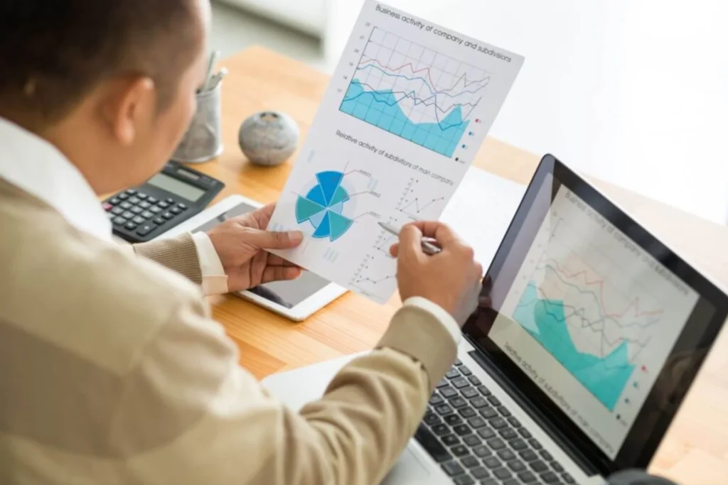 Man studies graphs on his laptop, emphasizing financial flexibility and strategic planning